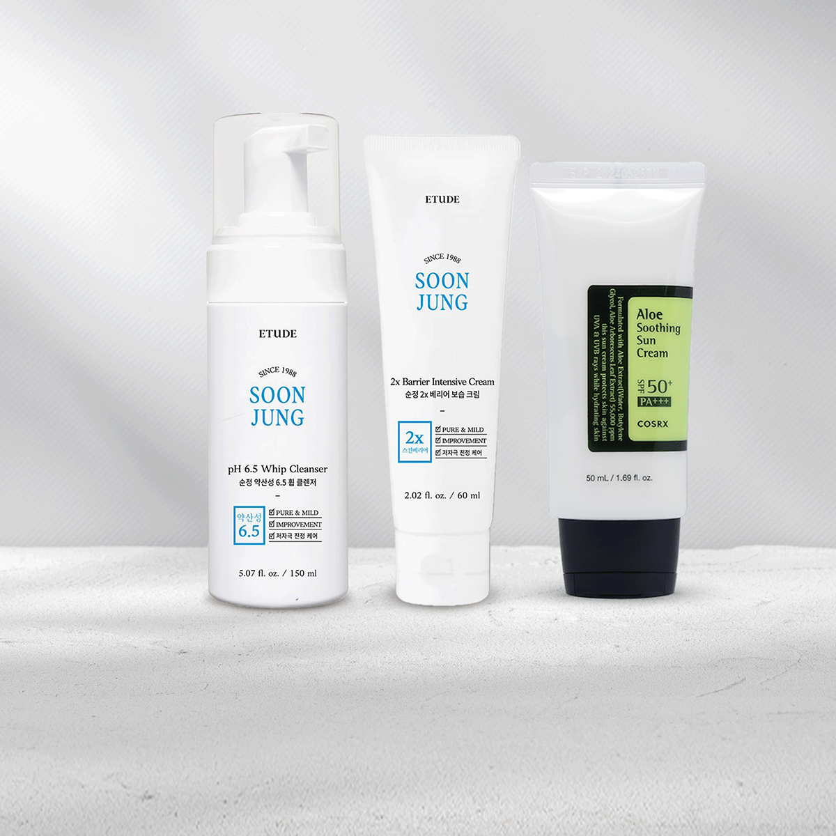 Skincare products including cleanser, moisturizer and suncare standing next to each other.